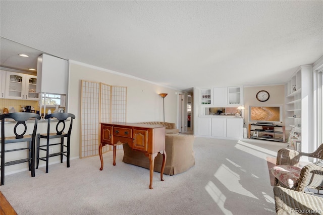 living room featuring light carpet, ornamental molding, and a textured ceiling