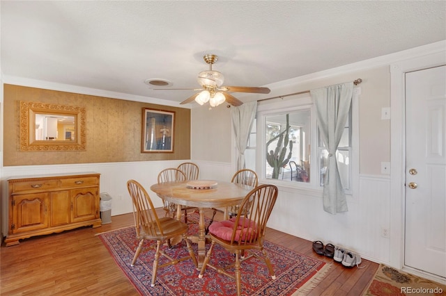 dining room featuring ceiling fan, a textured ceiling, and light wood-type flooring