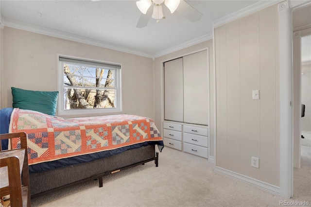 carpeted bedroom with ornamental molding and ceiling fan