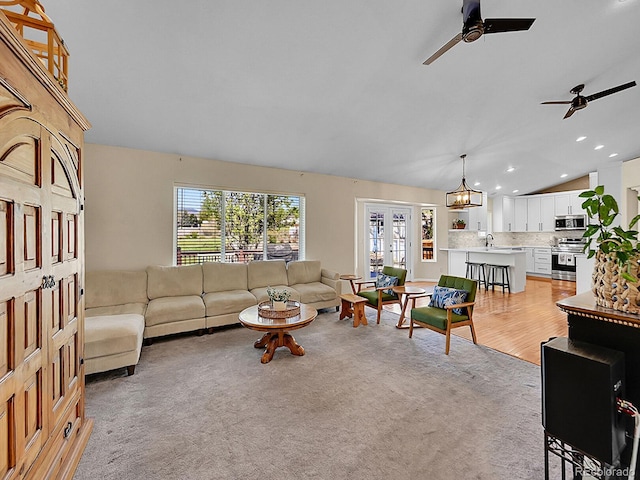 7809 S Flower St, Littleton, CO 80128 - living area with a ceiling fan, vaulted ceiling, recessed lighting, and a chandelier