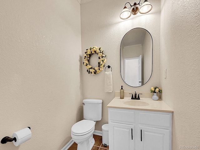 7809 S Flower St, Littleton, CO 80128 - bathroom with toilet, vanity, baseboards, and tile patterned floors