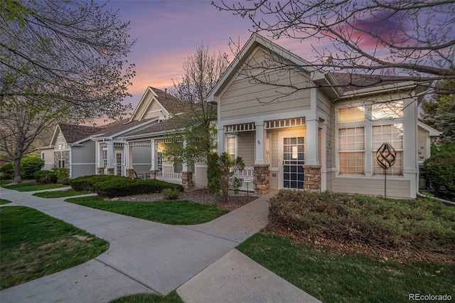 8300 Fairmount Dr Unit M103, Denver, CO 80247 - view of front of house with a porch and stone siding