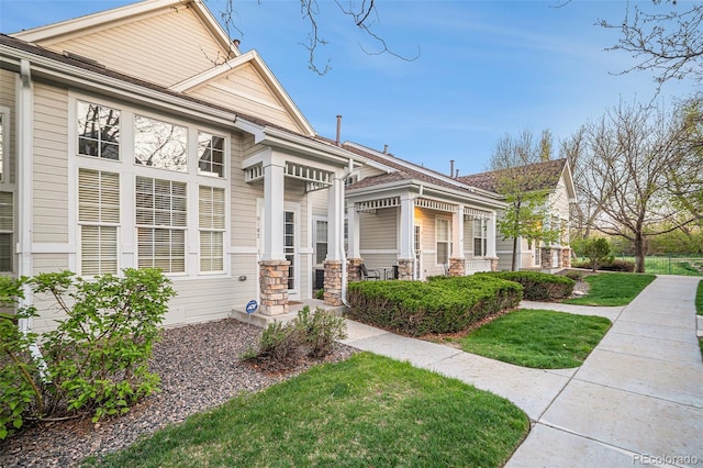8300 Fairmount Dr Unit M103, Denver, CO 80247 - view of front facade with a front lawn and covered porch