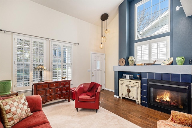 8300 Fairmount Dr Unit M103, Denver, CO 80247 - living room with a high ceiling, wood finished floors, and a tiled fireplace