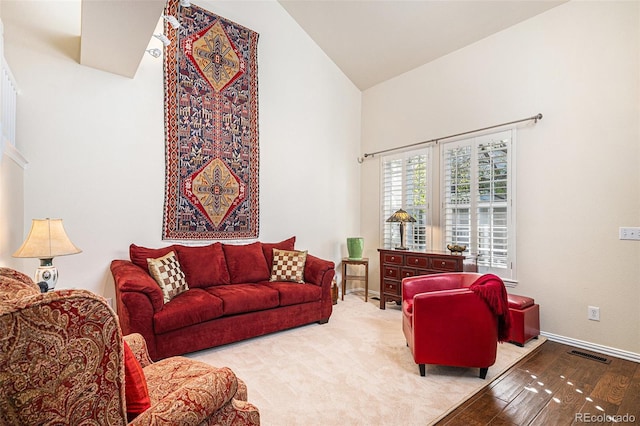 8300 Fairmount Dr Unit M103, Denver, CO 80247 - living area featuring high vaulted ceiling and baseboards
