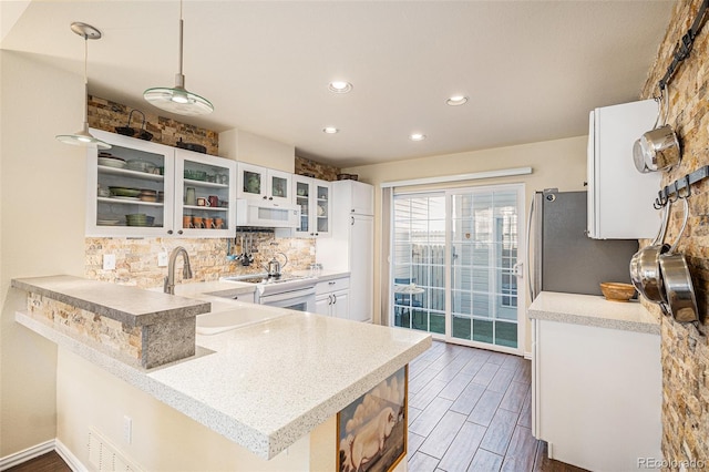 8300 Fairmount Dr Unit M103, Denver, CO 80247 - kitchen featuring white appliances, a sink, tasteful backsplash, white cabinets, and light countertops