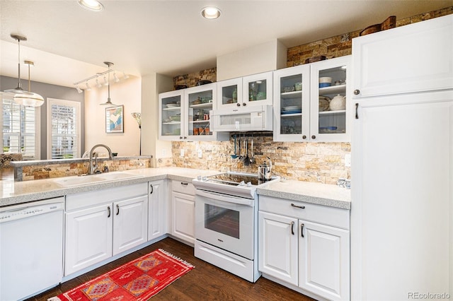 8300 Fairmount Dr Unit M103, Denver, CO 80247 - kitchen with white appliances, a sink, tasteful backsplash, decorative light fixtures, and glass insert cabinets