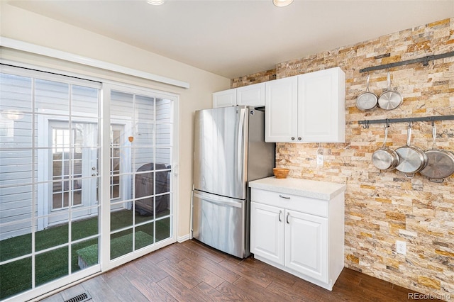 8300 Fairmount Dr Unit M103, Denver, CO 80247 - kitchen with freestanding refrigerator, dark wood finished floors, and white cabinetry