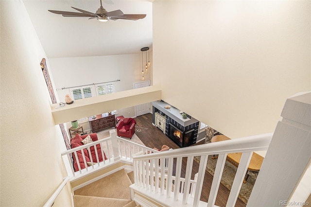 8300 Fairmount Dr Unit M103, Denver, CO 80247 - staircase with ceiling fan, lofted ceiling, and a fireplace