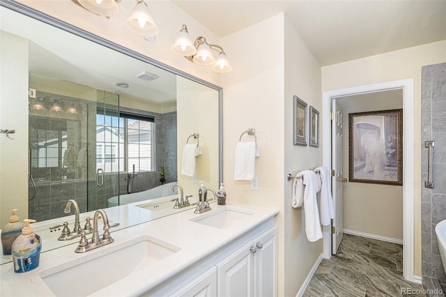 8300 Fairmount Dr Unit M103, Denver, CO 80247 - bathroom featuring a soaking tub, baseboards, a stall shower, marble look tiles, and double vanity