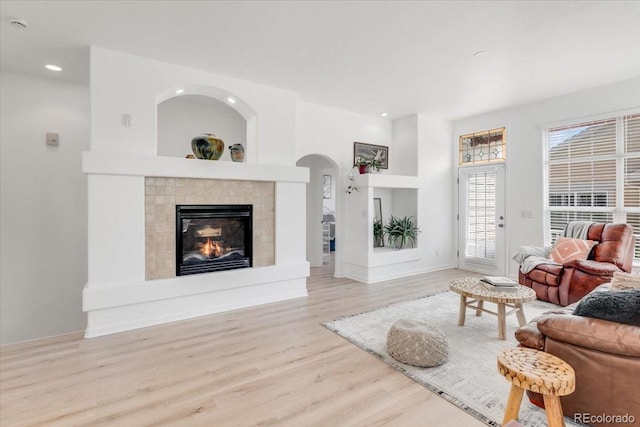 3862 E 127th Ln, Thornton, CO 80241 - living room featuring wood finished floors, recessed lighting, a fireplace, and arched walkways