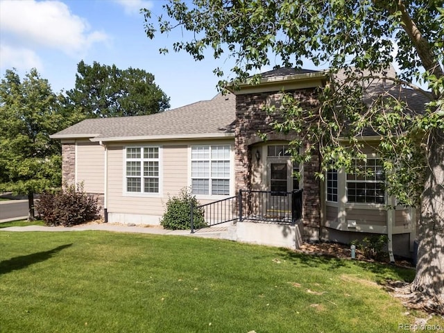 3862 E 127th Ln, Thornton, CO 80241 - view of front of home featuring a front yard, roof with shingles, and stone siding