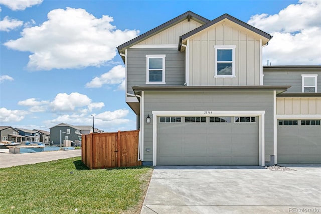 28564 E 6th Pl, Watkins, CO 80137 - view of front of house featuring board and batten siding, an attached garage, and concrete driveway