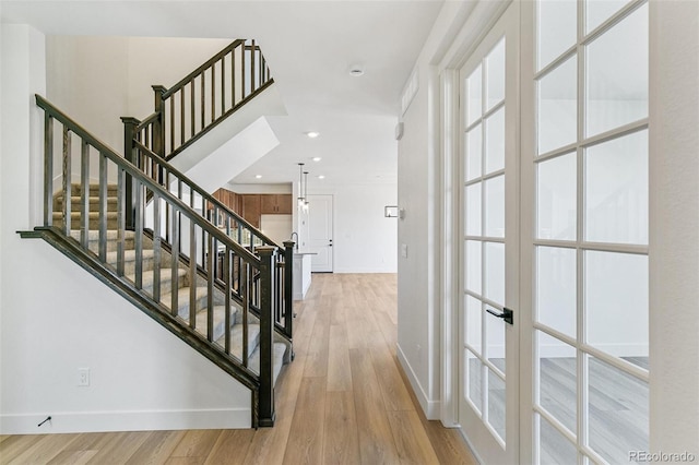 28564 E 6th Pl, Watkins, CO 80137 - entrance foyer with french doors, light wood-style flooring, stairs, plenty of natural light, and recessed lighting