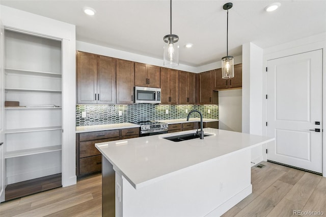 28564 E 6th Pl, Watkins, CO 80137 - kitchen featuring stainless steel appliances, light wood-style flooring, light countertops, and recessed lighting