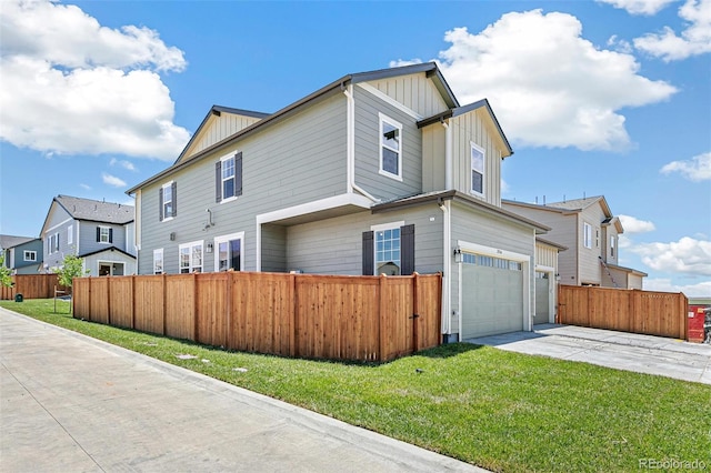 28564 E 6th Pl, Watkins, CO 80137 - view of property exterior featuring board and batten siding, an attached garage, concrete driveway, and a residential view