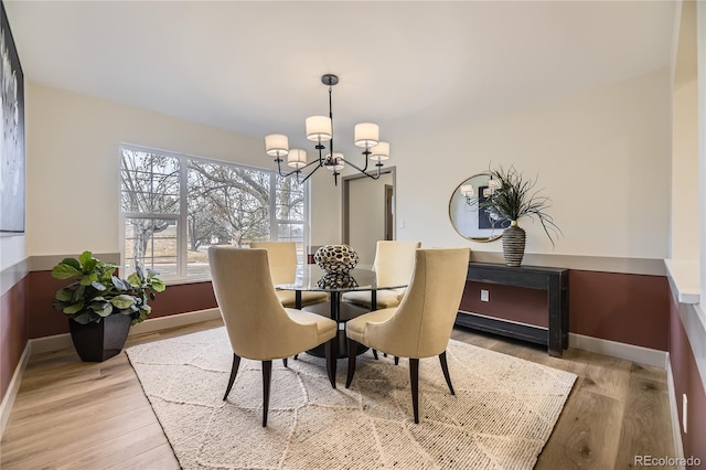 dining room featuring a chandelier and light wood-type flooring