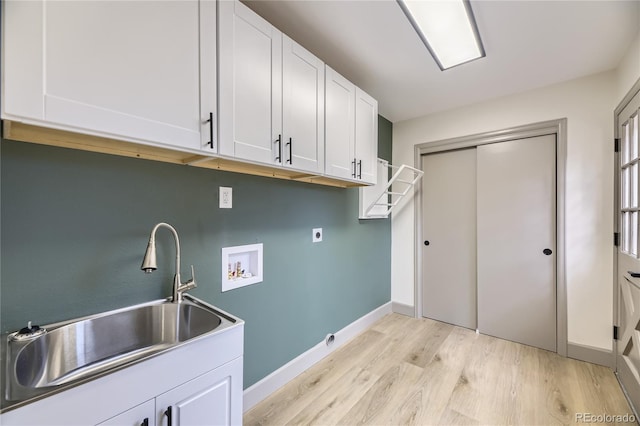 washroom with sink, cabinets, light hardwood / wood-style floors, hookup for a washing machine, and hookup for an electric dryer