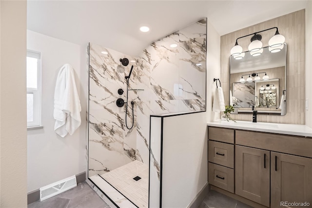 bathroom featuring vanity and a tile shower