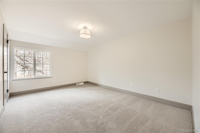 unfurnished room with light carpet