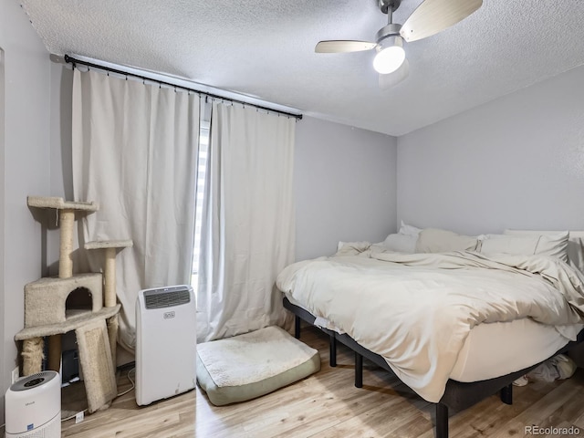 10895 Fairfax Way, Thornton, CO 80233 - bedroom with light wood-style flooring, a textured ceiling, and ceiling fan