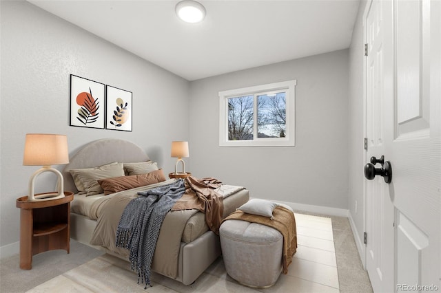 bedroom featuring light carpet and baseboards