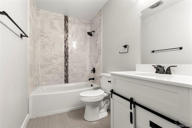 full bath featuring shower / bath combination, a textured wall, vanity, and toilet