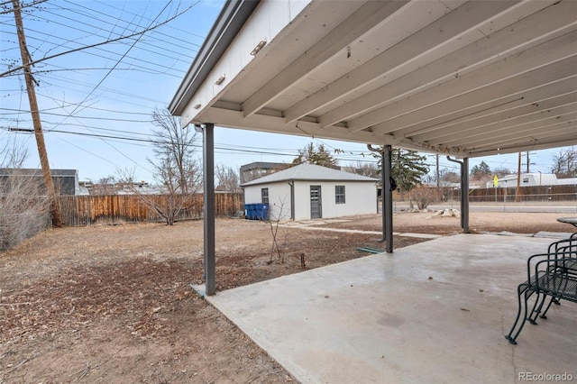 view of patio / terrace with an outdoor structure and a fenced backyard