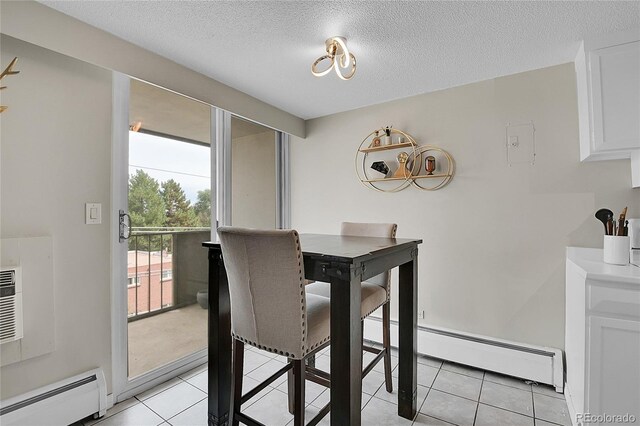 dining room featuring a textured ceiling, a baseboard radiator, and light tile patterned flooring