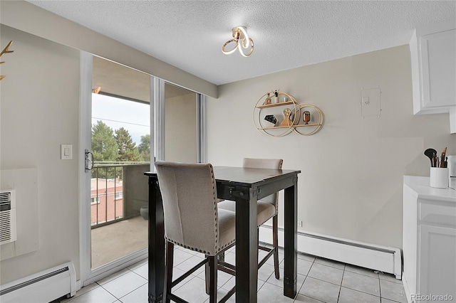 dining space with a baseboard heating unit, a textured ceiling, and light tile patterned flooring