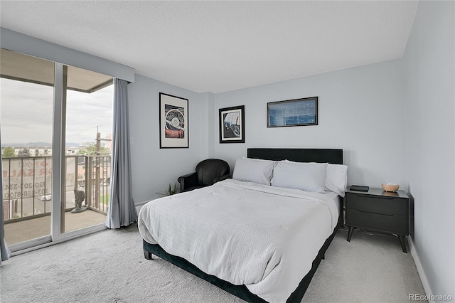 bedroom with a textured ceiling, access to outside, carpet, and baseboards