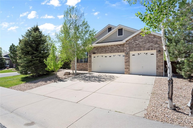 view of front of property featuring concrete driveway, brick siding, and a garage