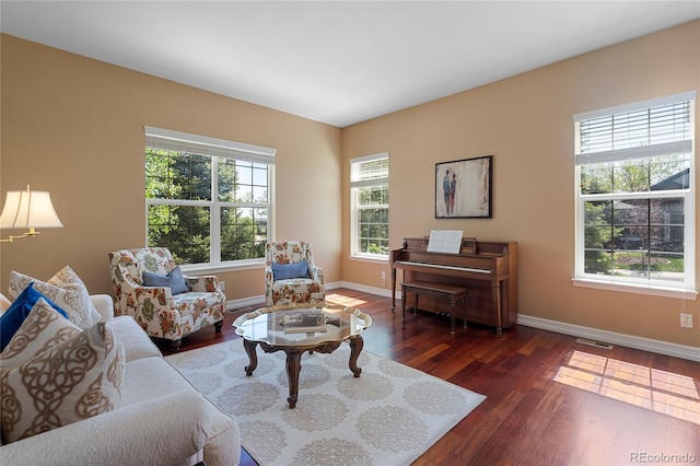 living room featuring baseboards and dark wood finished floors