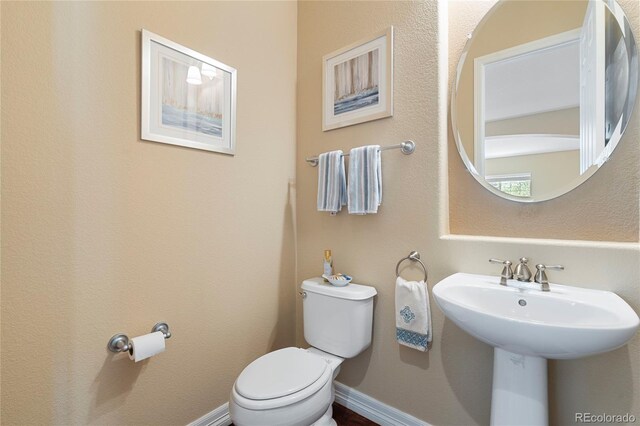 bathroom featuring toilet and a sink