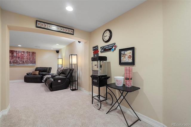 carpeted living area with baseboards and recessed lighting