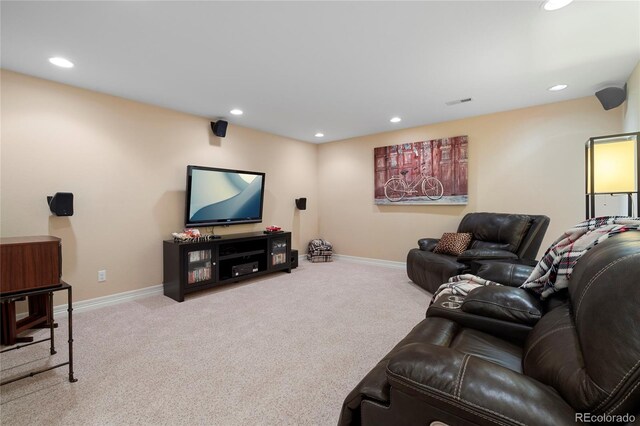 carpeted living area with recessed lighting and baseboards