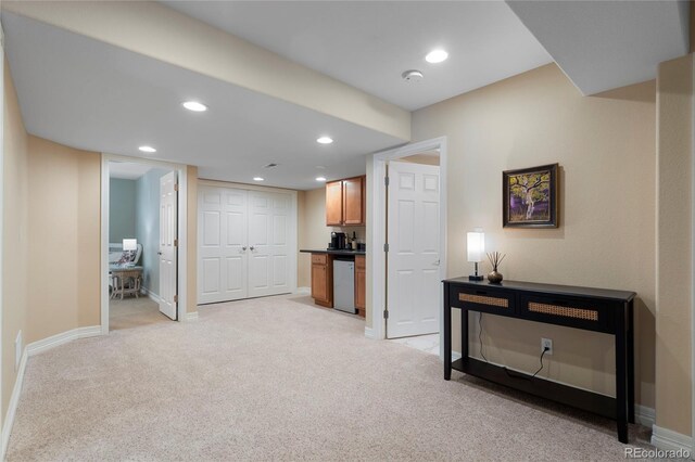 hallway featuring light carpet, baseboards, and recessed lighting