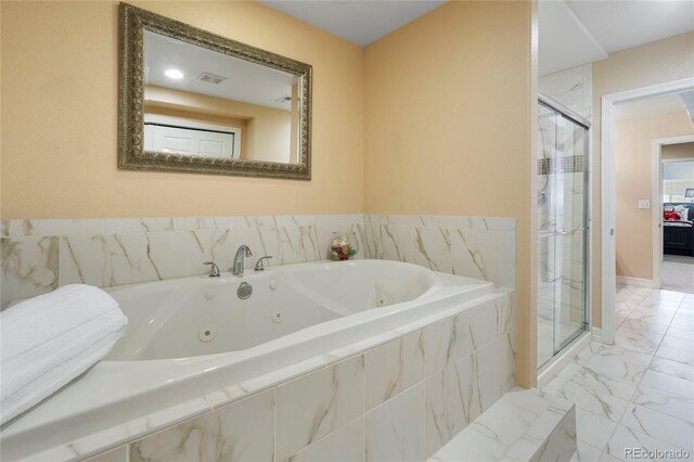 bathroom with a tub with jets, a shower stall, and marble look tiles