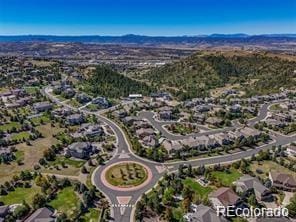 aerial view of property and surrounding area featuring mountains and nearby suburban area