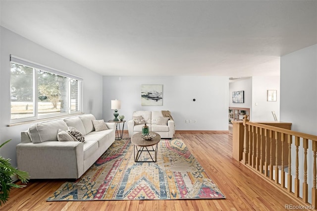 living area featuring baseboards and wood finished floors