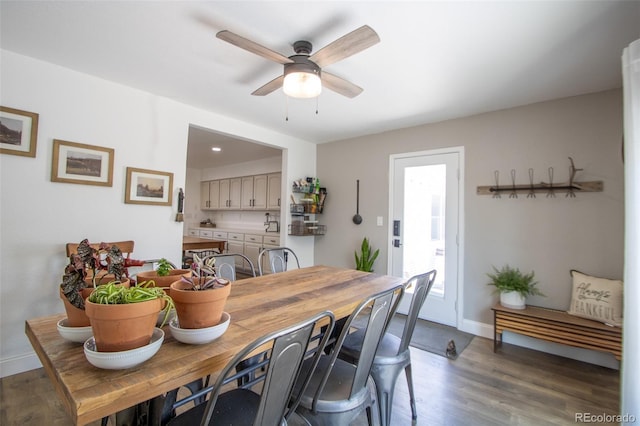 50 S Dickson St, Keenesburg, CO 80643 - dining area featuring wood finished floors, a ceiling fan, and baseboards