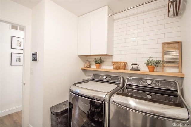 50 S Dickson St, Keenesburg, CO 80643 - laundry area featuring cabinet space, independent washer and dryer, baseboards, and wood finished floors
