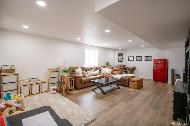 50 S Dickson St, Keenesburg, CO 80643 - living area featuring recessed lighting, wood finished floors, and baseboards