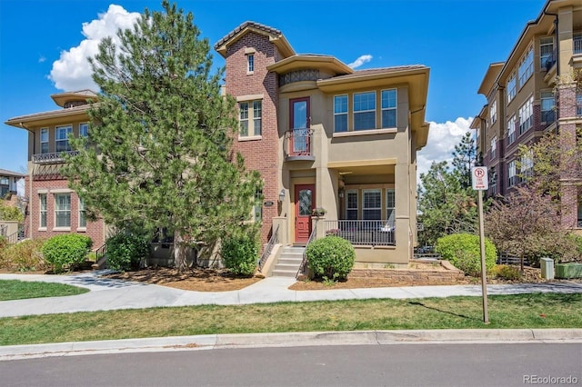 view of front of home with stucco siding and brick siding