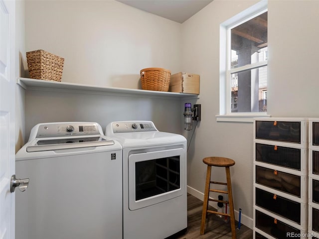 clothes washing area with independent washer and dryer and dark wood-type flooring