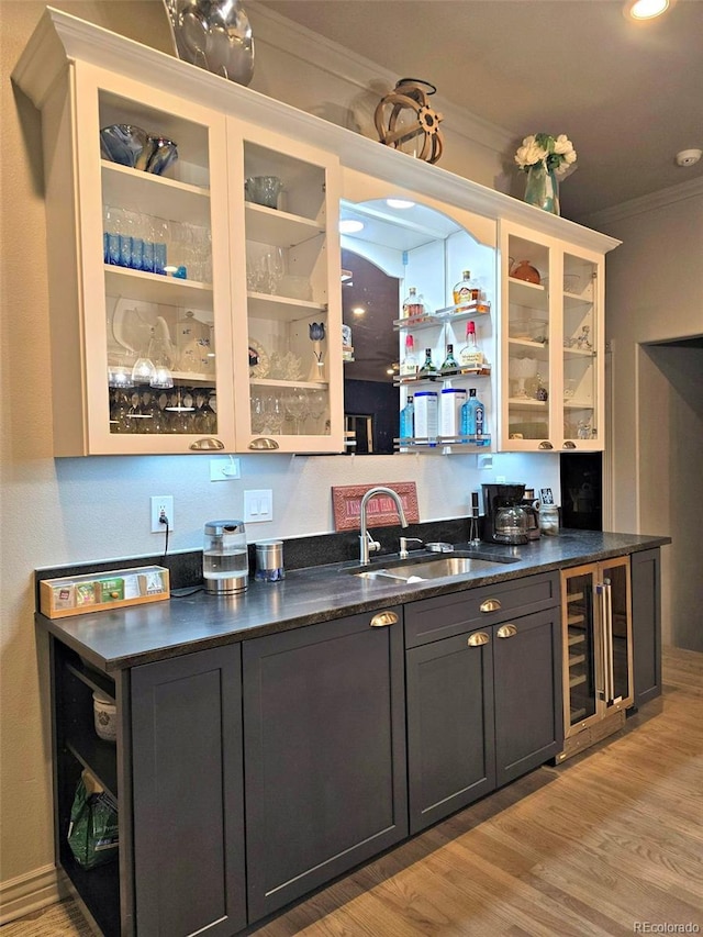 83 Wilderness Cornerstone Rd, Evergreen, CO 80439 - indoor bar featuring crown molding, beverage cooler, and light wood-style floors