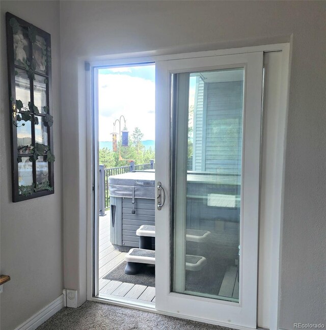 83 Wilderness Cornerstone Rd, Evergreen, CO 80439 - doorway featuring baseboards, healthy amount of natural light, and carpet flooring