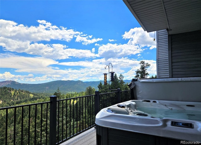 83 Wilderness Cornerstone Rd, Evergreen, CO 80439 - wooden terrace featuring a mountain view and a hot tub