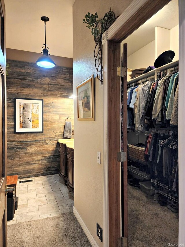 83 Wilderness Cornerstone Rd, Evergreen, CO 80439 - hall featuring wood walls, light carpet, and baseboards