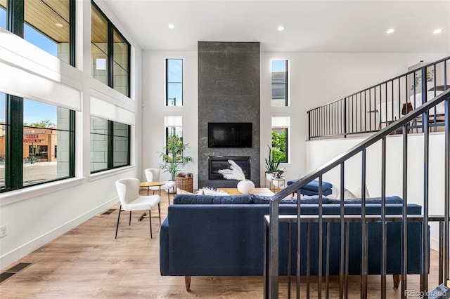 living room with light wood-type flooring and a premium fireplace